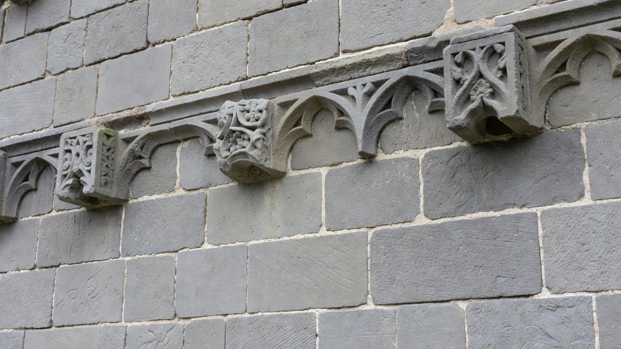 Detailed view of ashlar stonework, lime mortar pointing and carved architectural details